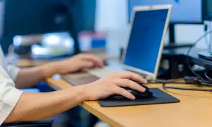Main gauche sur la souris, main droite sur le clavier. Le travail sur ordinateur peut causer une douleur épaule.