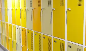 Rangée de casiers jaunes et beiges, numérotés, conformes au vestiaire code du travail.