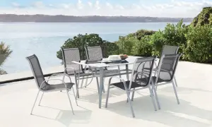 Table et chaises d'extérieur en aluminium, un inconvénient : peut chauffer au soleil. Vue sur mer.