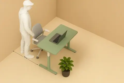 Un homme se tient près d'un bureau vert avec un ordinateur portable. La distance entre le bureau et le mur est de 100 cm.