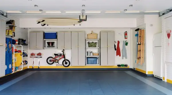 Aménagement d'atelier impeccable : surf, vélo, rangements, tout est à sa place pour un espace fonctionnel et organisé.
