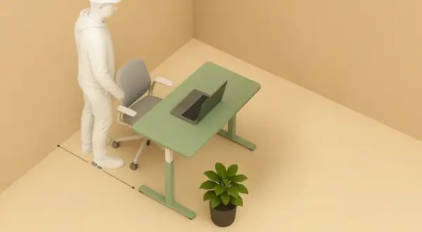 Un homme se tient près d'un bureau vert avec un ordinateur portable. La distance entre le bureau et le mur est de 100 cm.