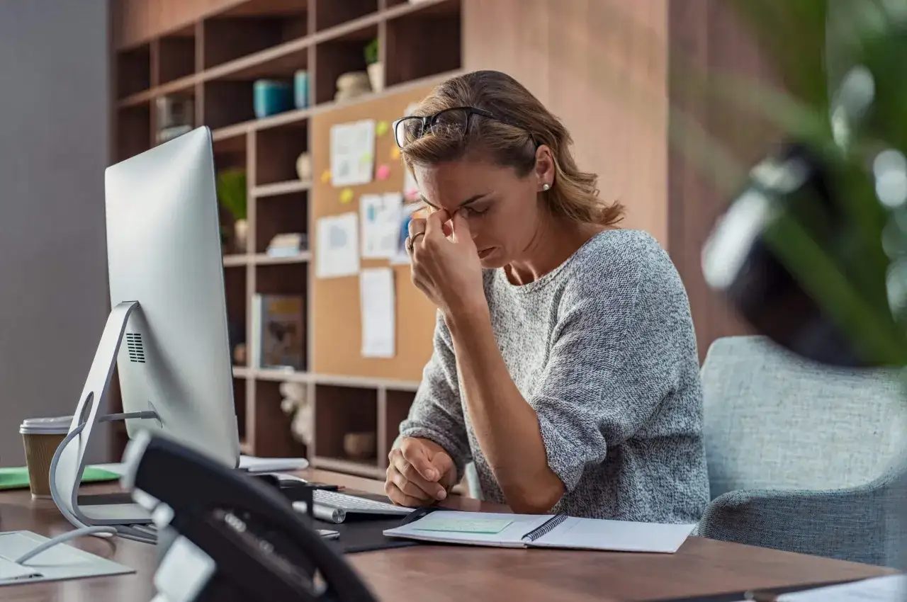 Femme fatigu&eacute;e au bureau, se frottant les yeux pour reposer les yeux. Elle a besoin d'une pause.