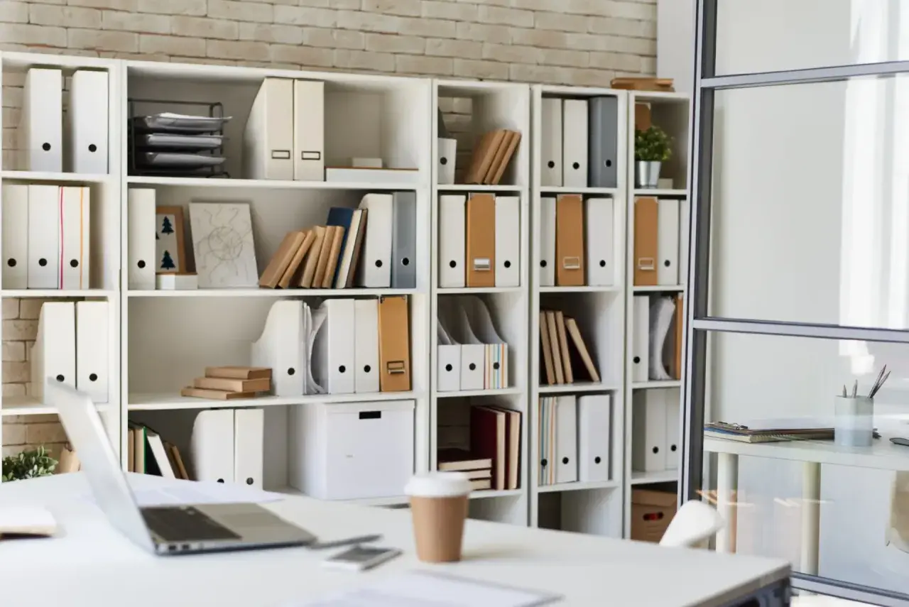 Étagères remplies de classeurs, livres et boîtes. Une excellente idée rangement bureau pour un espace organisé.